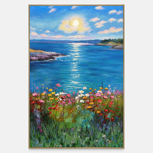 Front view of a sunlit blue sea between low shores with colorful flowers in the foreground, with a gold-colored frame.