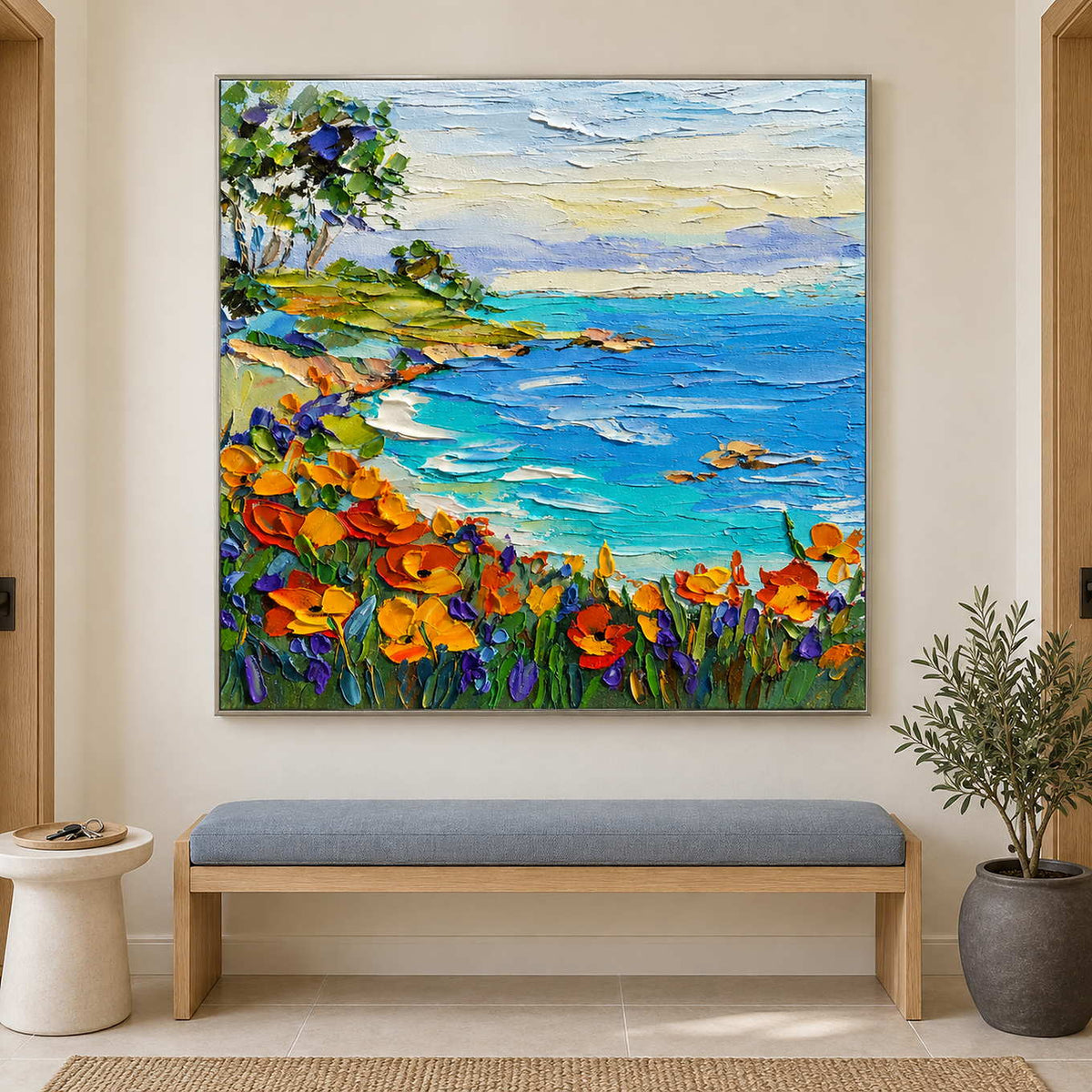 Square coastal landscape above a blue upholstered bench.