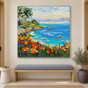 Square coastal landscape above a blue upholstered bench.