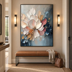 Vertical ivory, blush, and midnight-blue sculpted floral painting, displayed in a hallway in a black frame.