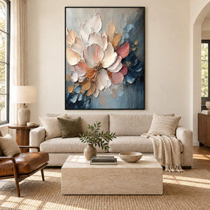 Vertical ivory, blush, and midnight-blue sculpted floral painting, displayed in a living room in a black frame.