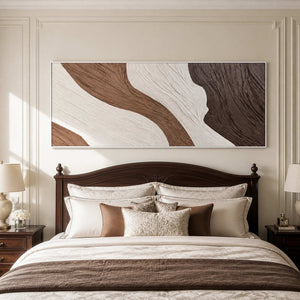 White-framed panoramic abstract wall art above a dark wooden bed with neutral pillows.
