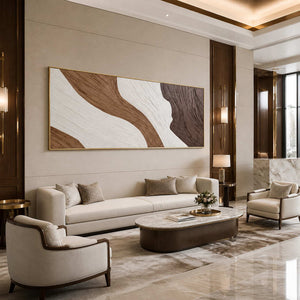 Gold-framed flowing abstract wall art above cream seating in a hotel lobby.