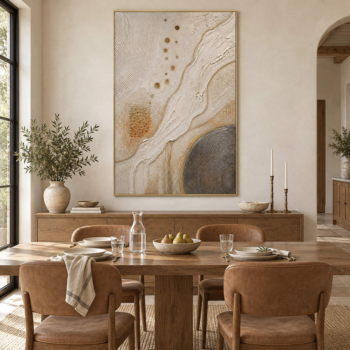 Ivory and gold relief painting with flowing ridges and textured circles in a gold frame in a dining room.