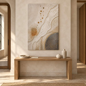 Ivory and gold relief painting with flowing ridges and textured circles without an outer frame in an entryway.