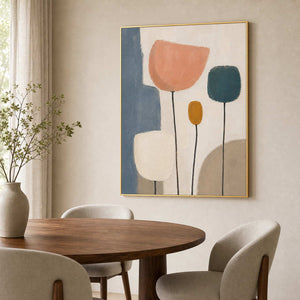 Abstract botanical wall art above a Scandinavian dining room.