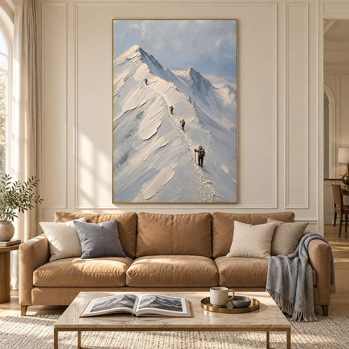 Snowy mountain painting with four climbers along a ridge in a gold frame in a living room.