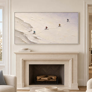 Four skiers crossing an open ivory-white slope in a white frame, displayed above a fireplace.