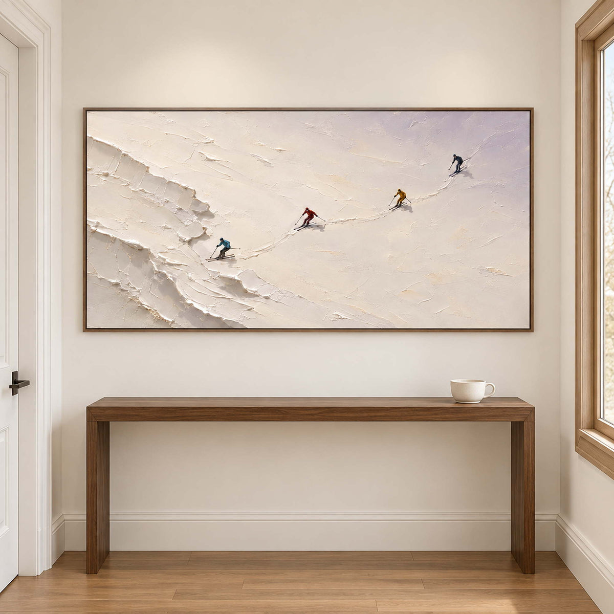 Four skiers crossing an open ivory-white slope in a brown wood frame, displayed in a hallway.
