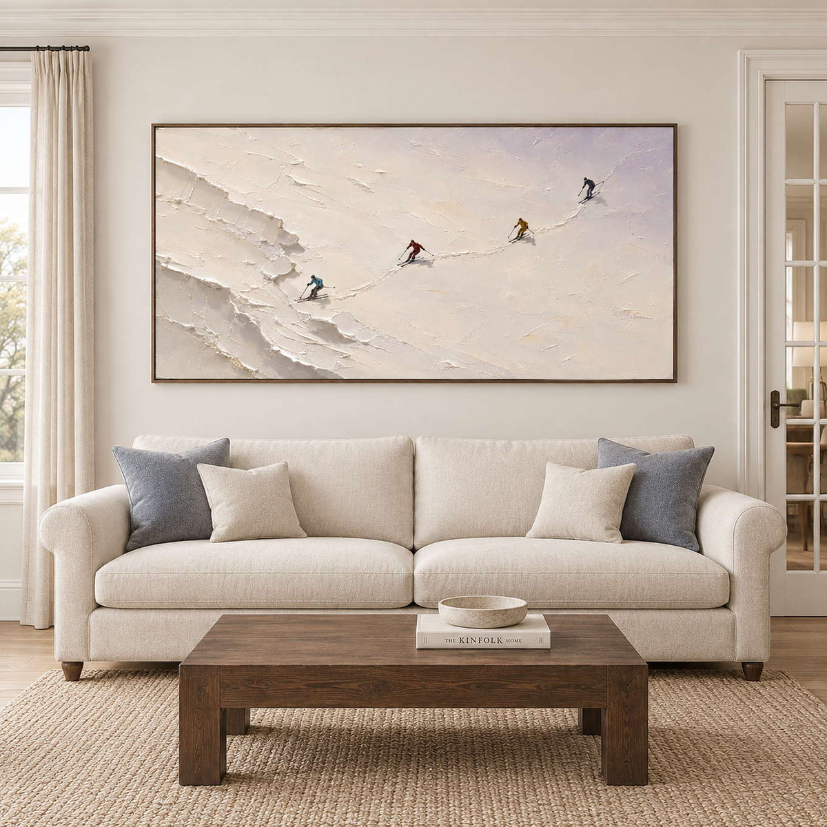 Four skiers crossing an open ivory-white slope in a brown wood frame, displayed above a sofa in a living room.