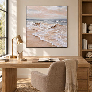 Free as the Sea in a black frame above a light wood desk and beige office chair.