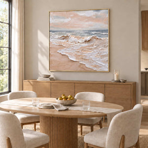 Free as the Sea in a gold frame above a light wood sideboard behind an oval dining table.