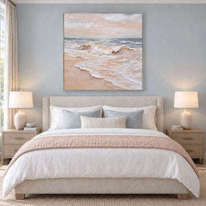 Free as the Sea in a silver frame above a cream bed with a blush throw and blue-gray cushions.