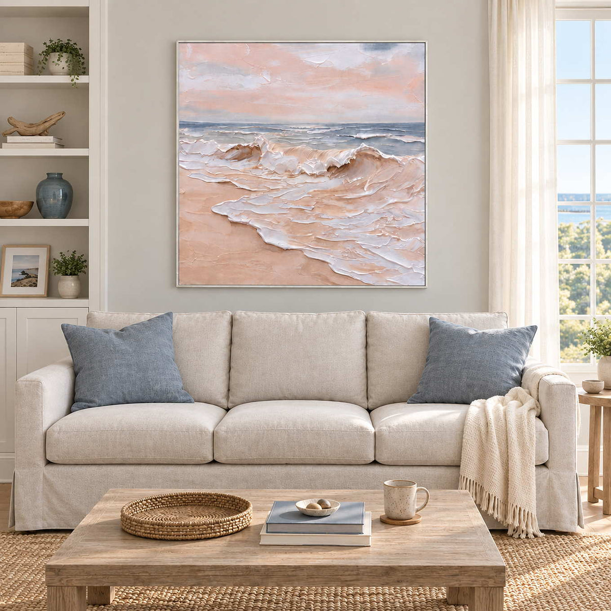 Free as the Sea in a white frame above a cream sofa with blue cushions and a pale wood coffee table.