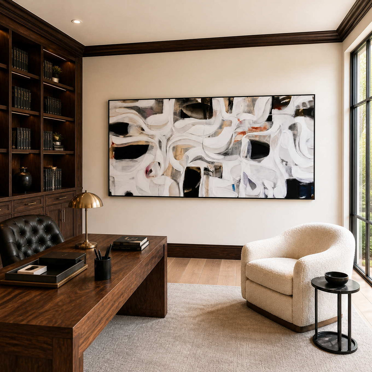 Black framed flowing abstract artwork above a wooden desk in a bright home office.