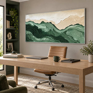 Free to Wander in a silver frame above a light wood desk and tan leather chair against a warm gray wall.