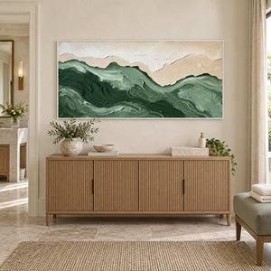 Free to Wander in a white frame above a fluted wood cabinet with towels and greenery beside a bathroom vanity.
