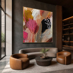 Gold framed pink and ochre abstract painting above seating in a boutique hotel lobby.