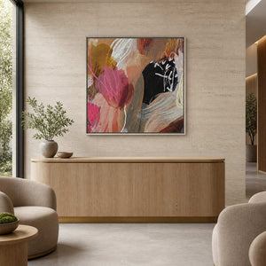 Warm colorful abstract painting in a silver frame behind a curved wellness reception counter.