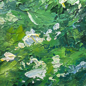 Macro view of thick green strokes and small white petals.