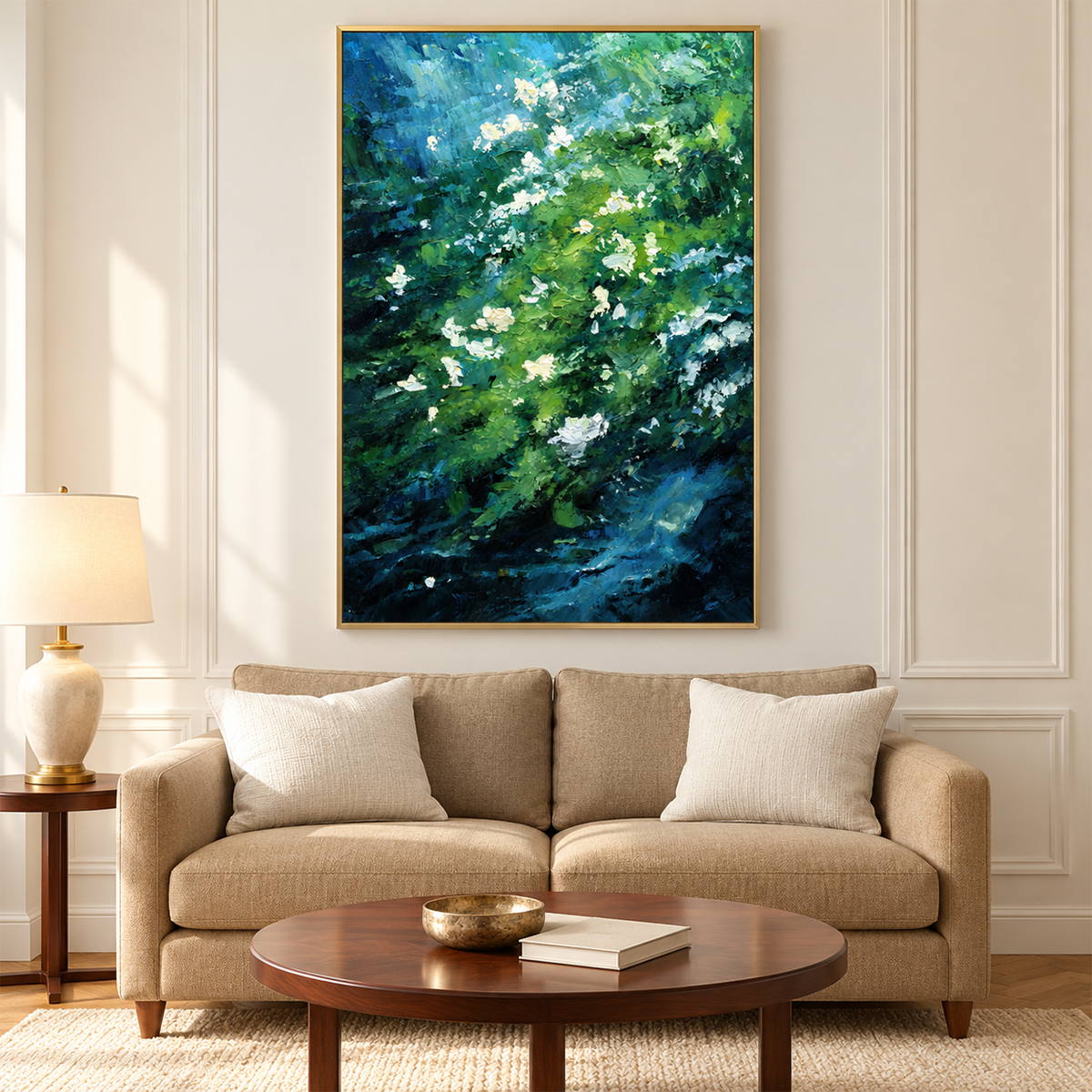 Small white flowers among diagonal layers of green and deep blue strokes in an artwork with a gold-colored frame, displayed in a living room above seating.