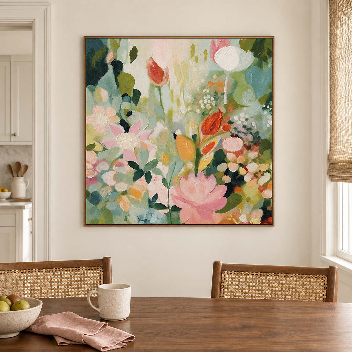 Pink, white and orange flowers among loose green leaves in a brown wood frame, displayed above a dining table.