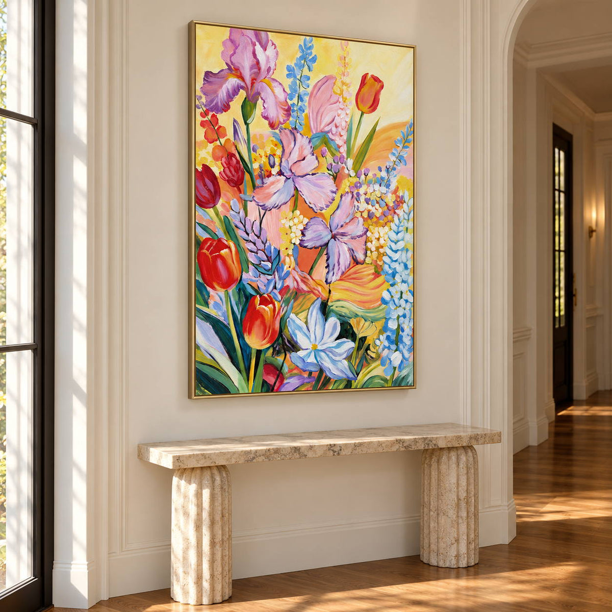 Purple flowers, red cup-shaped blooms and blue-white sprays on yellow in an artwork with a gold-colored frame, displayed in a hallway above a bench.