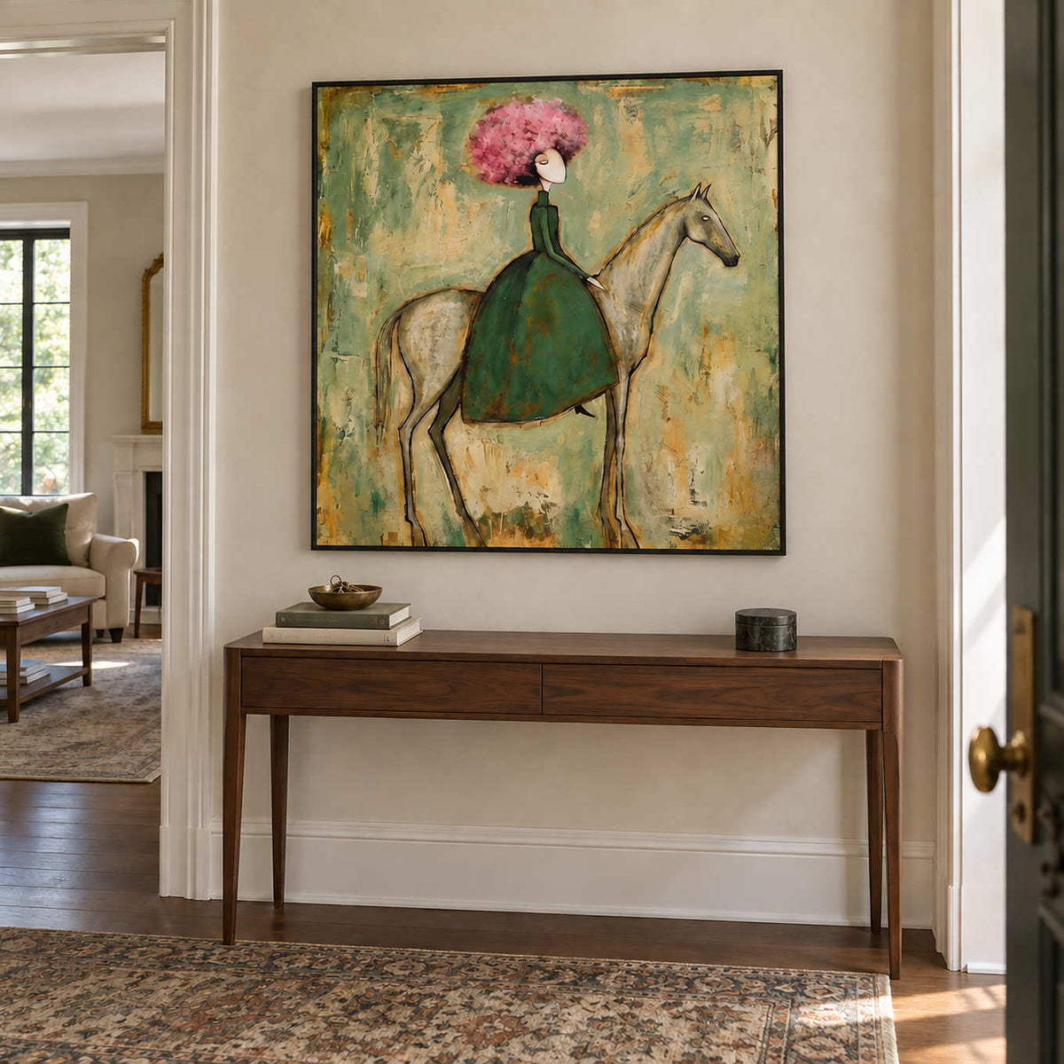 Gentle Company in a black frame above a slim dark wood hallway console with books and a small bowl.