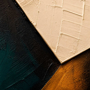 Close-up of ivory, deep teal, black, and ochre paint texture.