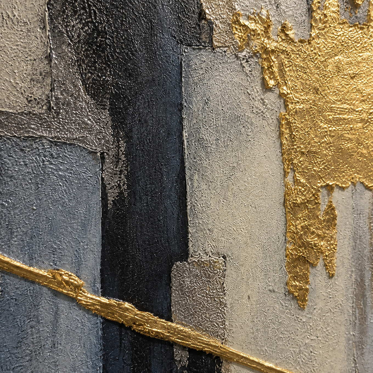 Close-up of raised gold, black, gray, and ivory abstract texture.