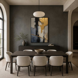 Textured gold abstract painting displayed in a charcoal dining room.