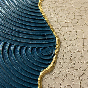 Close-up of ridged blue texture, crackled ivory, and gold edging.