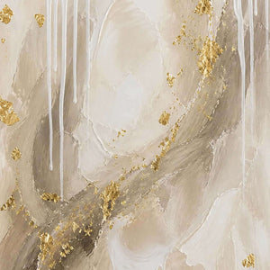 Close-up of ivory layers, pale stone, white drips, and gold leaf.