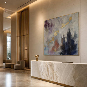 Gold-accented abstract painting in an ivory boutique hotel reception.