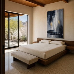 Black and grey abstract painting displayed above a serene modern bed.
