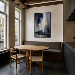 Vertical black and grey wall art displayed in a canal-side breakfast room.