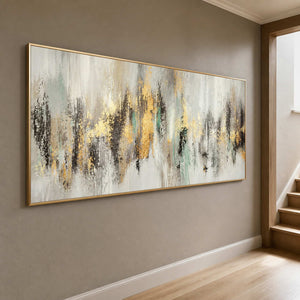Wide gold abstract artwork displayed beside a softly lit stairway.