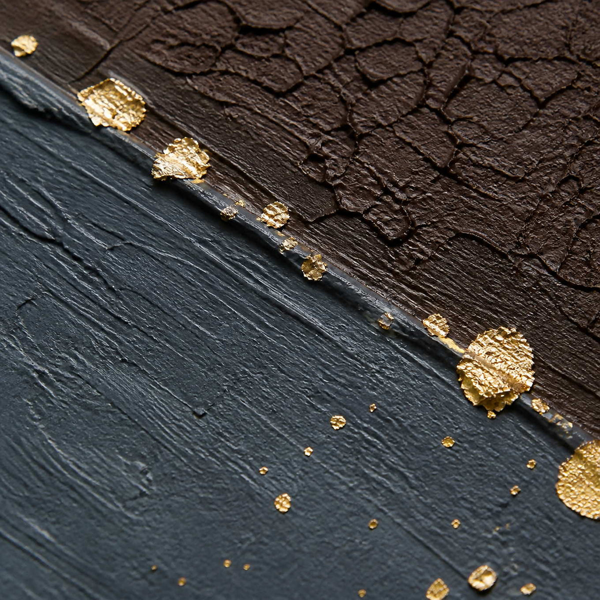 Close detail of cracked umber texture and luminous gold flecks.
