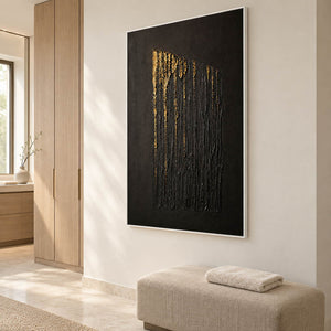 Hand-painted vertical abstract canvas with carved black ridges and gold relief, displayed in a bathroom dry area in a white frame.