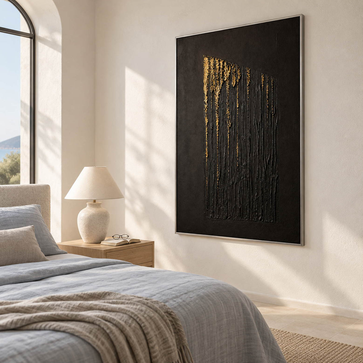 Hand-painted vertical abstract canvas with carved black ridges and gold relief, displayed in a bedroom in a silver frame.