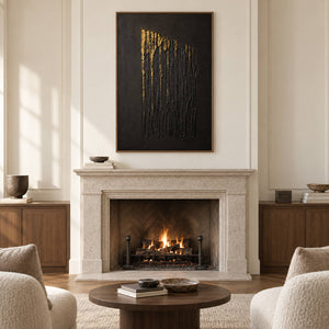 Hand-painted vertical abstract canvas with carved black ridges and gold relief, displayed beside or above a fireplace in a brown wood frame.
