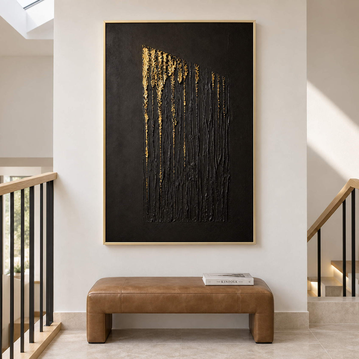 Hand-painted vertical abstract canvas with carved black ridges and gold relief, displayed beside a staircase in a gold frame.
