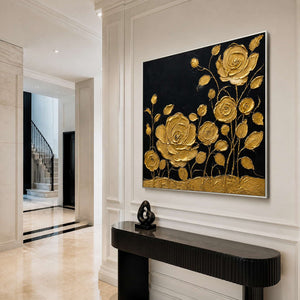 Square gold floral wall art in a luxury entryway with a silver frame.