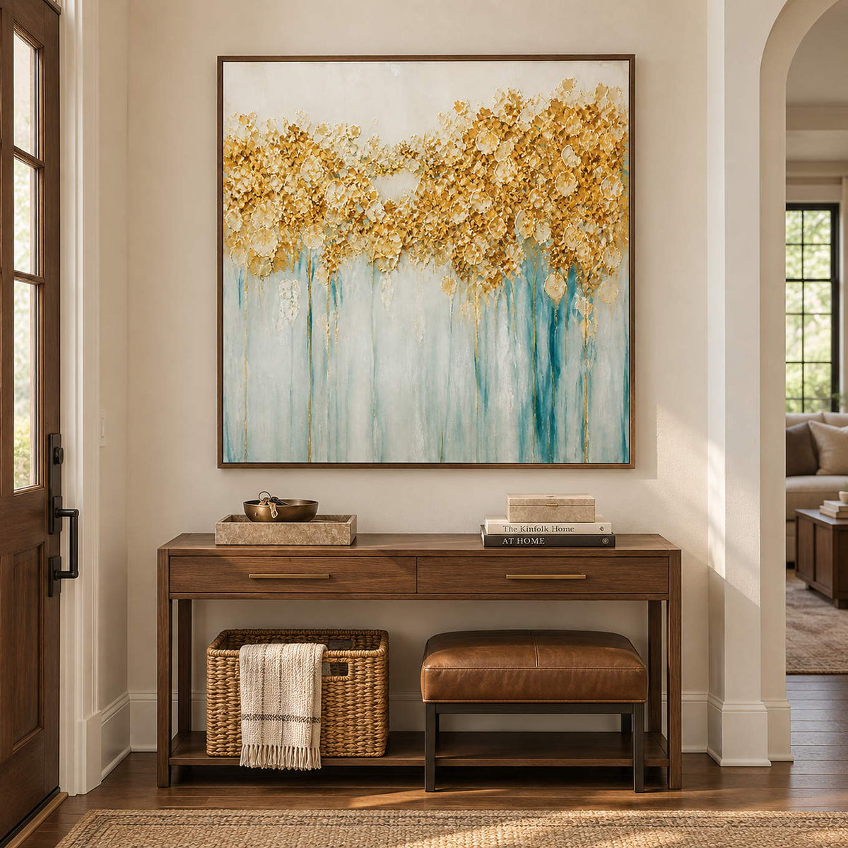 Hand-painted gold blossoms above soft aqua and ivory drips on canvas, displayed in an entryway in a brown wood frame.