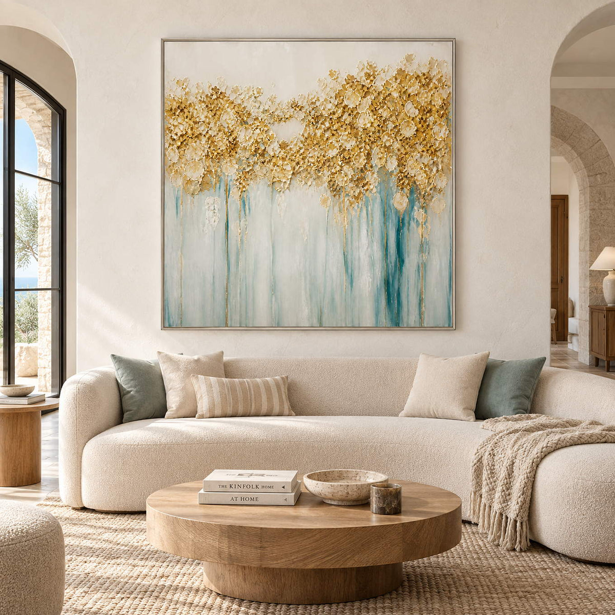 Hand-painted gold blossoms above soft aqua and ivory drips on canvas, displayed in a living room in a silver frame.