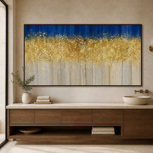 Wood framed blue and gold artwork above a bathroom vanity with a stone basin.