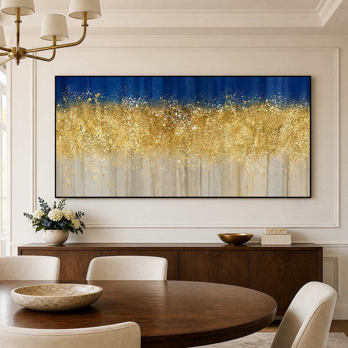 Black framed gold and blue abstract painting above a sideboard behind a round dining table.