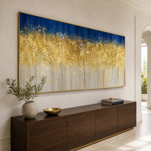 Gold framed panoramic abstract artwork above a walnut console beside an arched hallway opening.