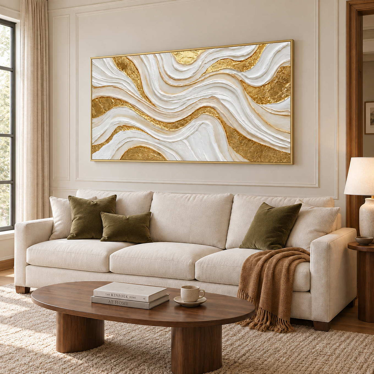 Golden Years in a gold frame above a cream sofa with olive cushions and an oval wood coffee table.