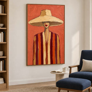 Tall coral portrait beside a navy reading chair and a small pale side table.